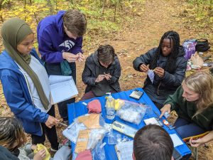 Students around a table doing field work